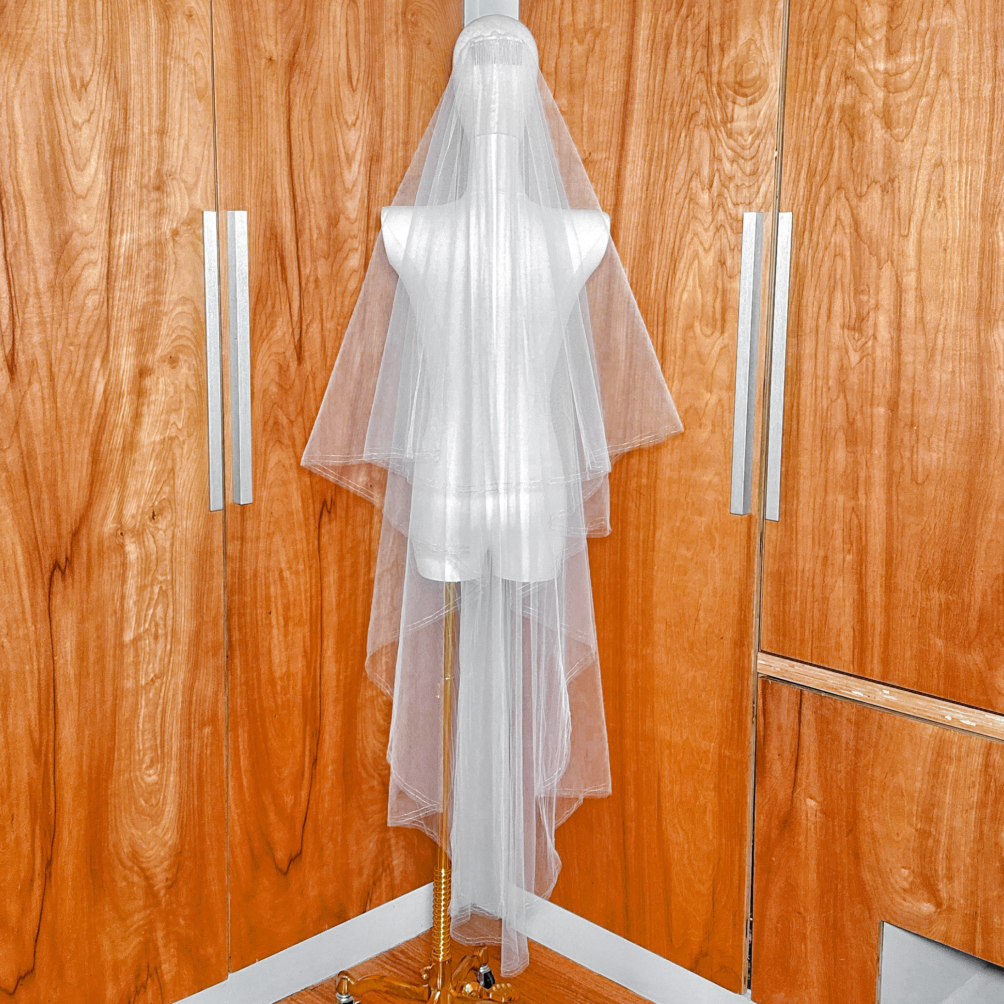 Back view of the gold metallic edge on a two tier waltz length veil with blusher.