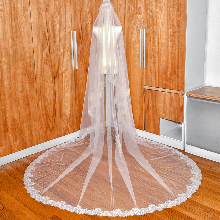 Handmade two tier Chantilly lace trim cathedral length veil shown on a professional mannequin.