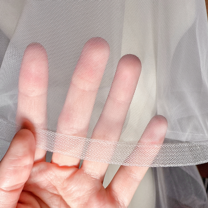 Close-up of the 1/2" horsehair trim on a two-tier cathedral wedding veil with blusher.