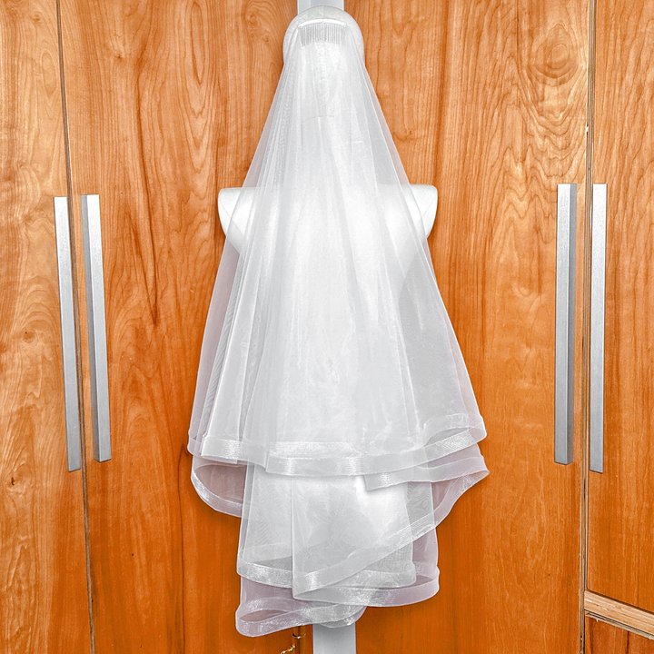 1 1/2" Horsehair Trim Wedding Veil with Blusher in fingertip length displayed on a mannequin.