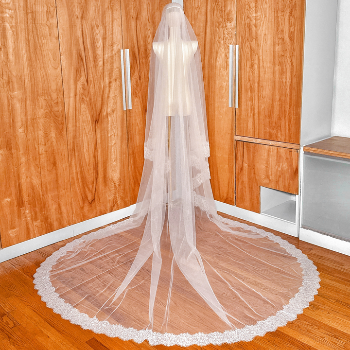 Ivory cathedral length wedding veil with a blusher and delicate Chantilly lace trim.