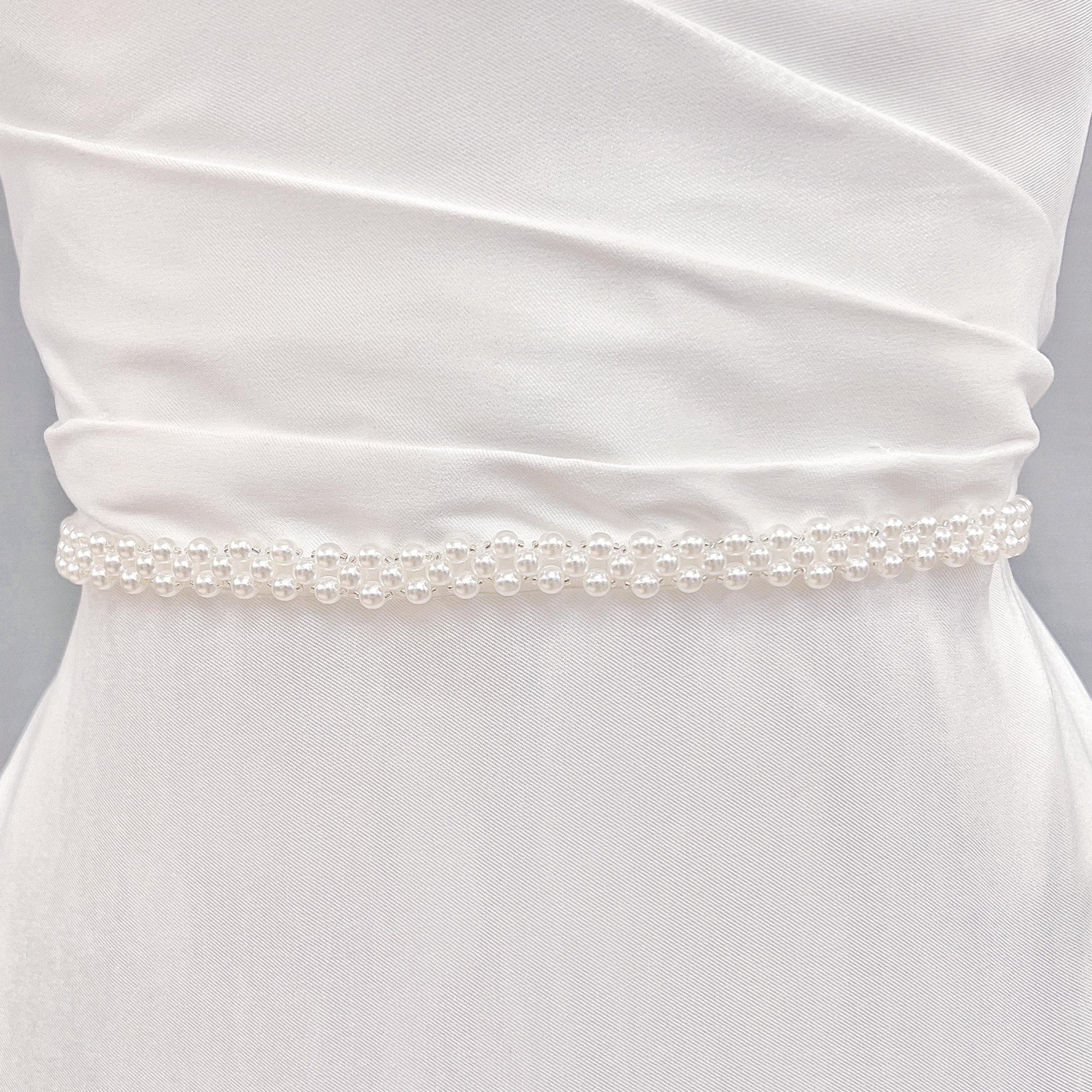 Ivory simple pearl bridal belt showcasing intricate beadwork and shimmering finish.