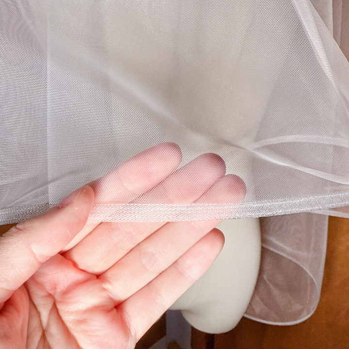 Close-up of the 1/4 inch horsehair trim on a two tier fingertip length wedding veil.