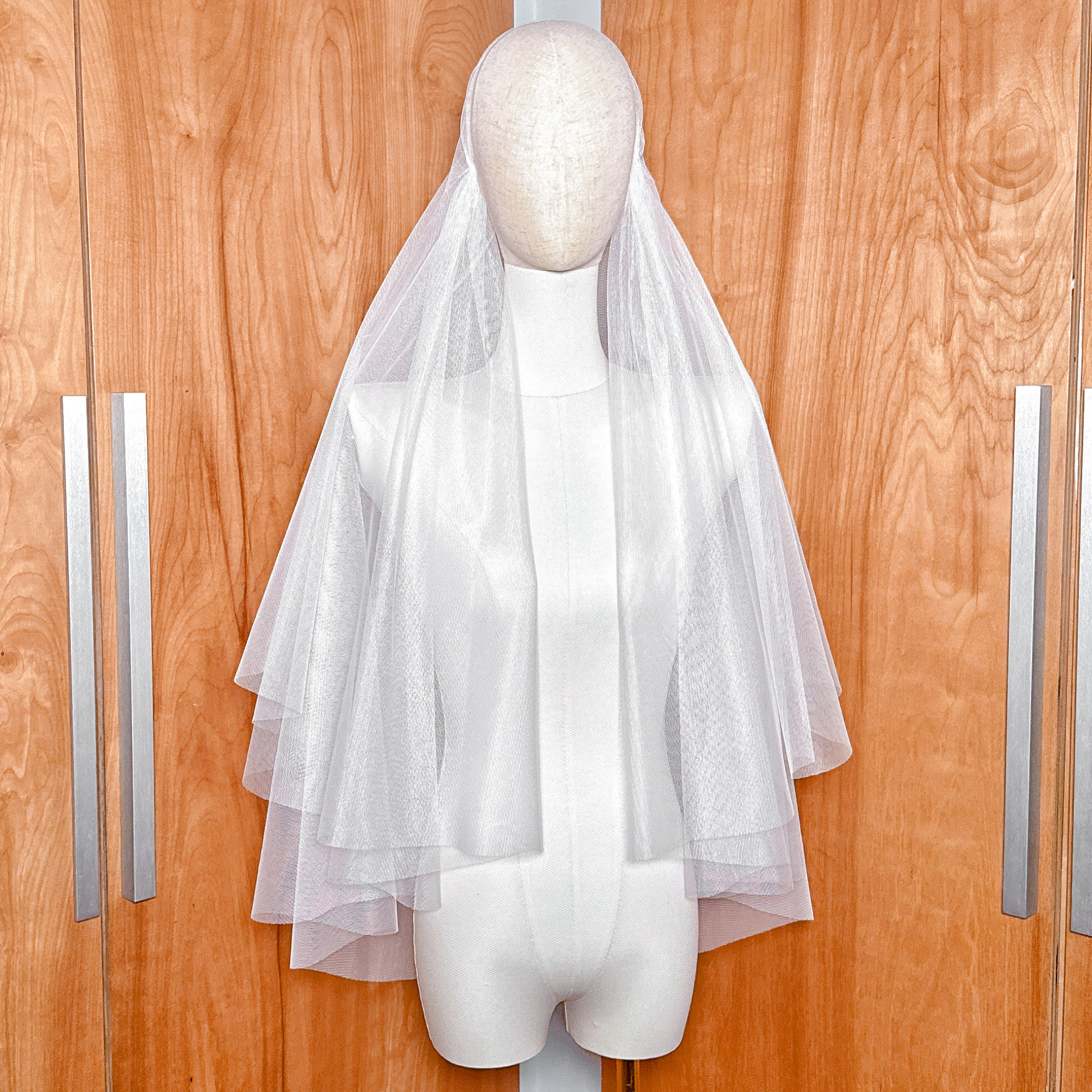 Juliet cap veil with blusher showing the flowing tulle.