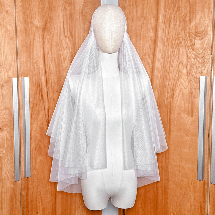Juliet cap veil with blusher showing the flowing tulle.