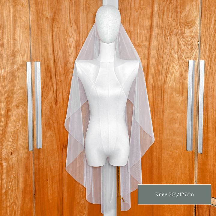 Front view of the clean raw edge finish on a knee length cascade wedding veil.