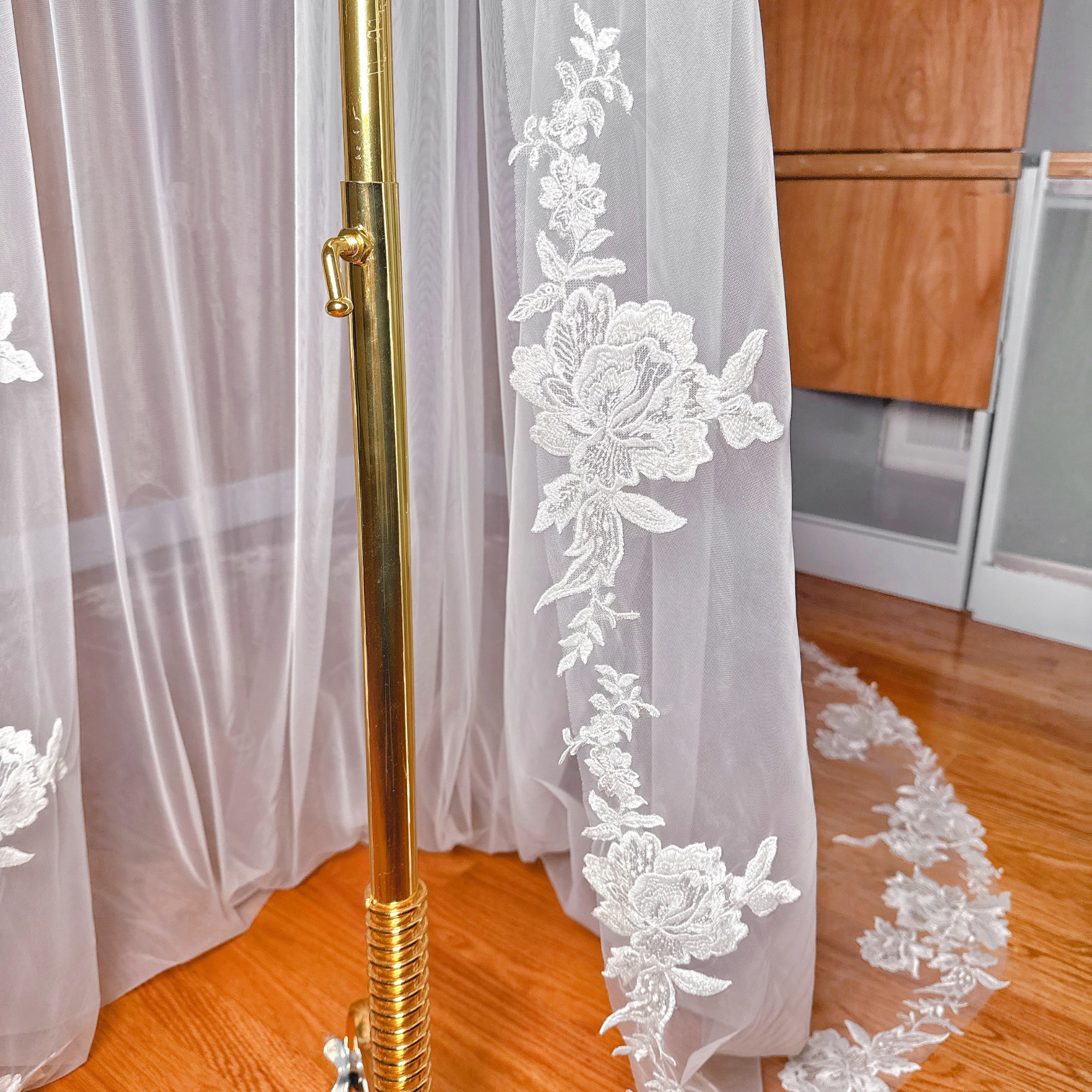 Close-up of the soft bridal tulle and scalloped lace edge of a cathedral length wedding veil.