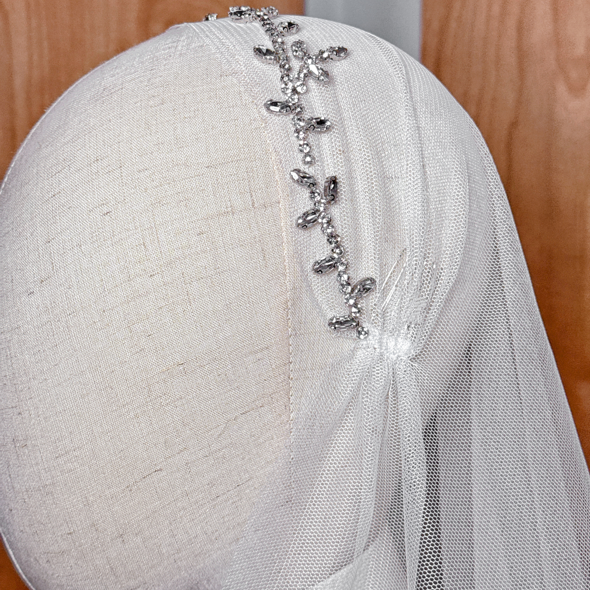 Close-up of the intricate leafy beadwork and embroidery on the Leafy Beaded Juliet Cap Veil.