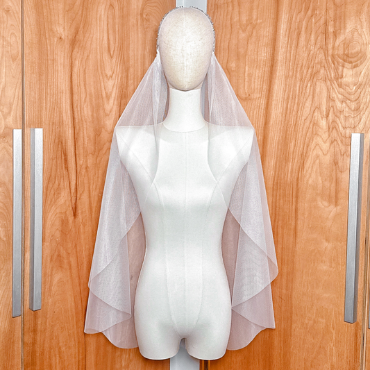 Front view of the Leafy Beaded Juliet Cap Veil in fingertip length displayed on a mannequin.