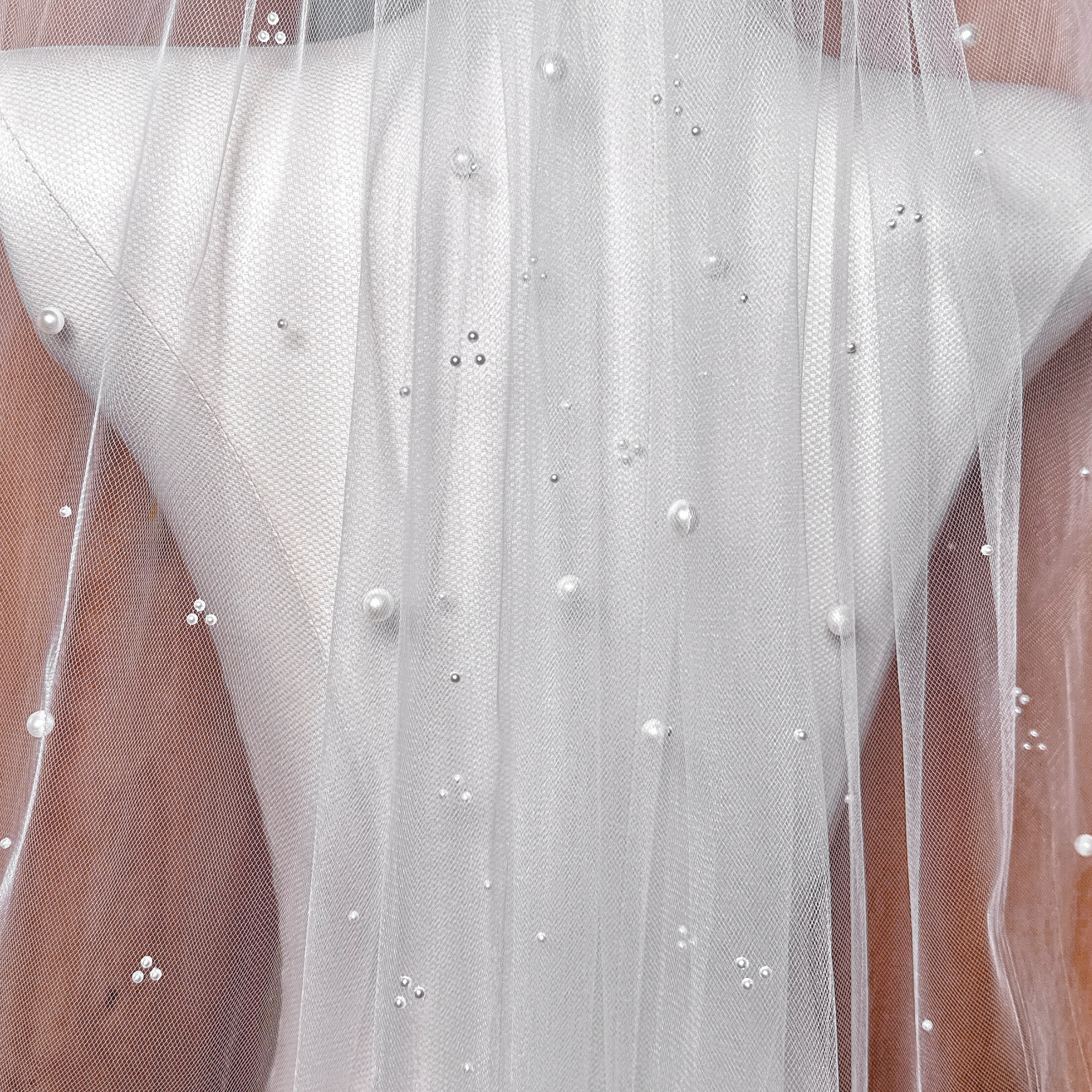 Lightweight elbow length scattered pearl wedding veil in sheer tulle, perfect for showing off bridal gown details.
