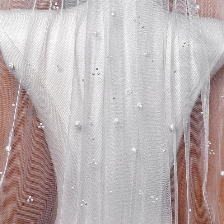 Lightweight elbow length scattered pearl wedding veil in sheer tulle, perfect for showing off bridal gown details.
