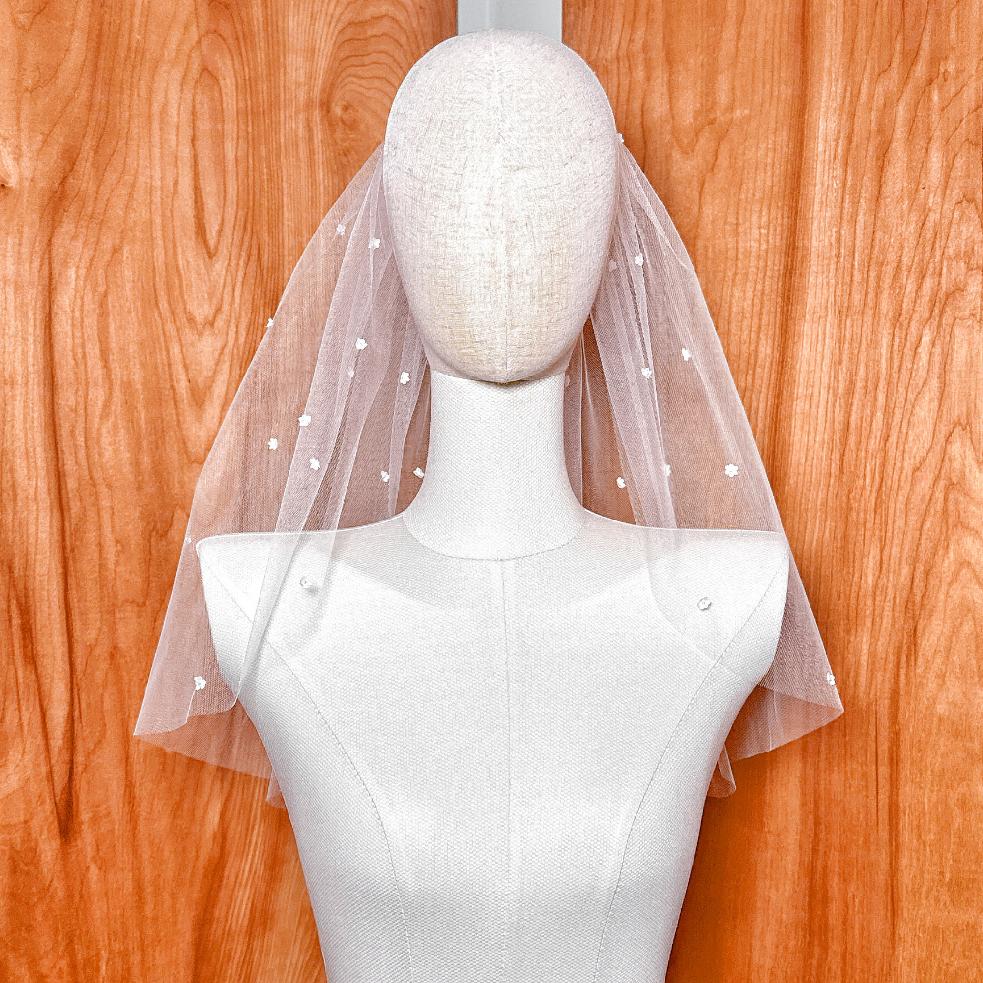 Detail shot of the top gathering, highlighting the sheer, lightweight quality of the premium Whisper Tulle cut to shoulder length.