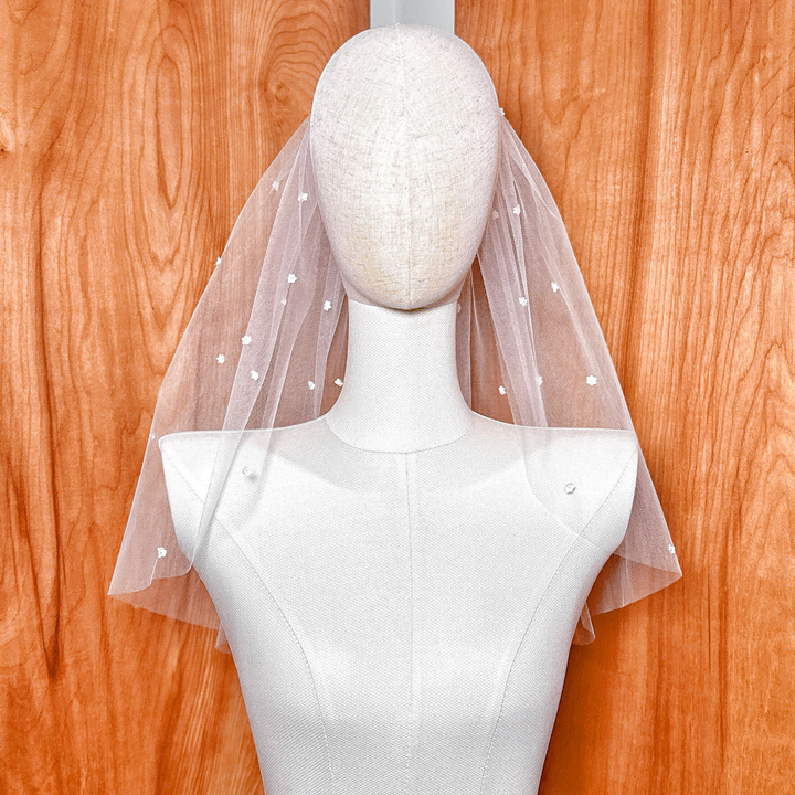 Detail shot of the top gathering, highlighting the sheer, lightweight quality of the premium Whisper Tulle cut to shoulder length.