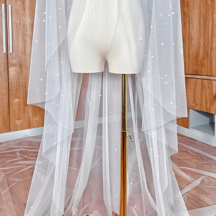Extra-long cascading scattered pearl bridal veil in royal cathedral length designed for a grand aisle walk.