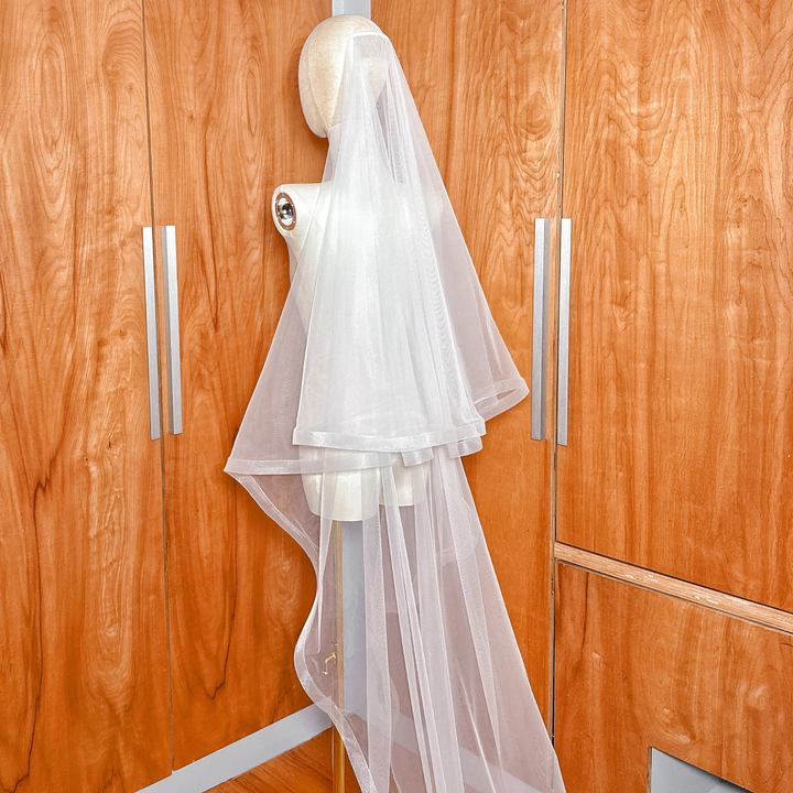 Detailed view of the 1 1/2 inch horsehair trim on a cathedral length wedding veil with blusher.