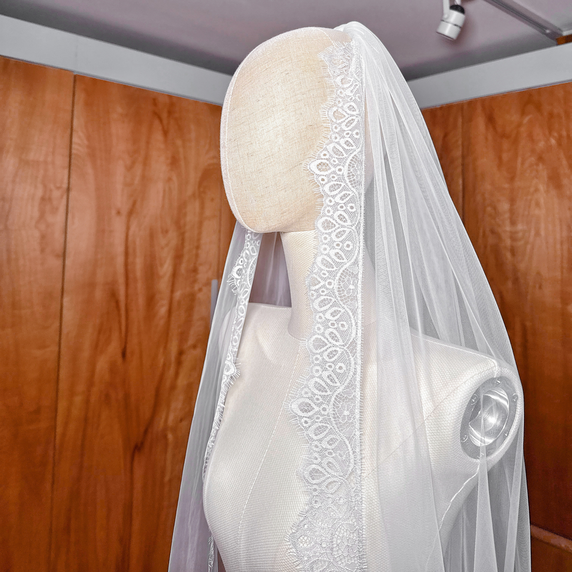 Floor-sweeping cathedral length Chantilly lace veil for a classic bridal look.