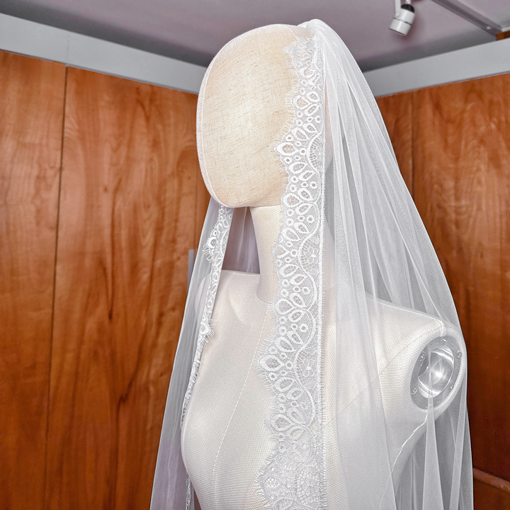 Floor-sweeping cathedral length Chantilly lace veil for a classic bridal look.