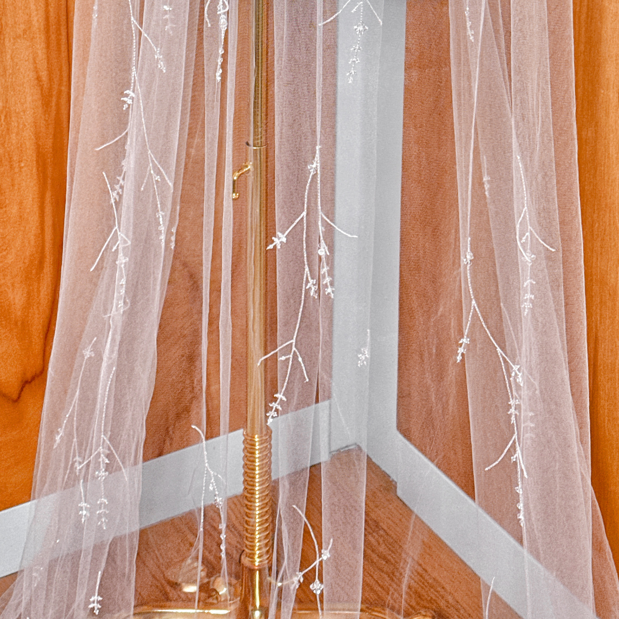 Luxury 3D floral embroidered bridal veil with crystals displayed on a mannequin.