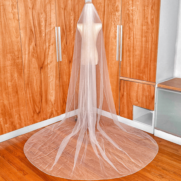 Back view of a luxury cathedral wedding veil highlighted by a shimmering beaded edge design.