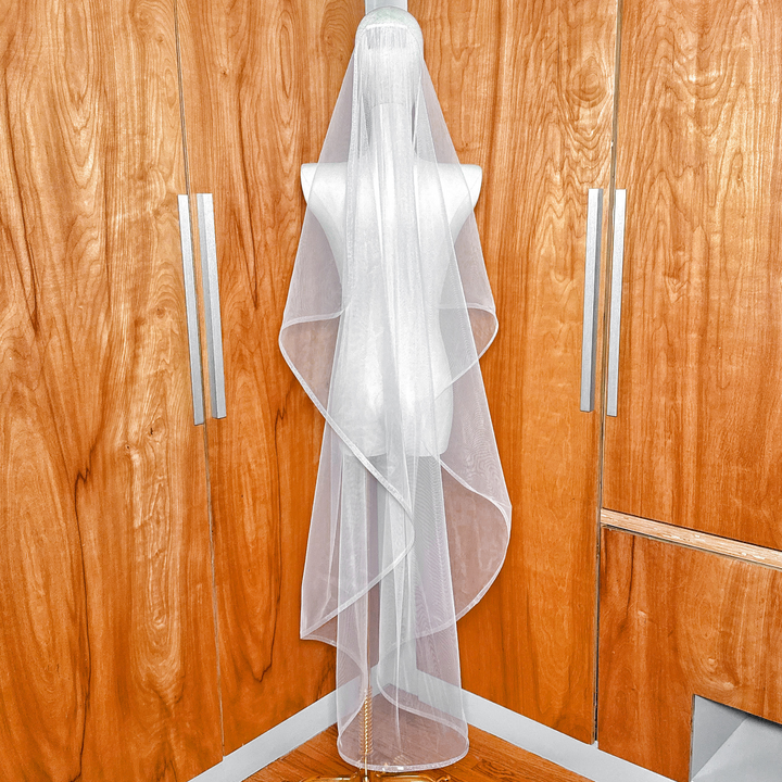 Full-length view of the cascade waltz wedding veil on a mannequin, showing the structured horsehair trim and waterfall silhouette.
