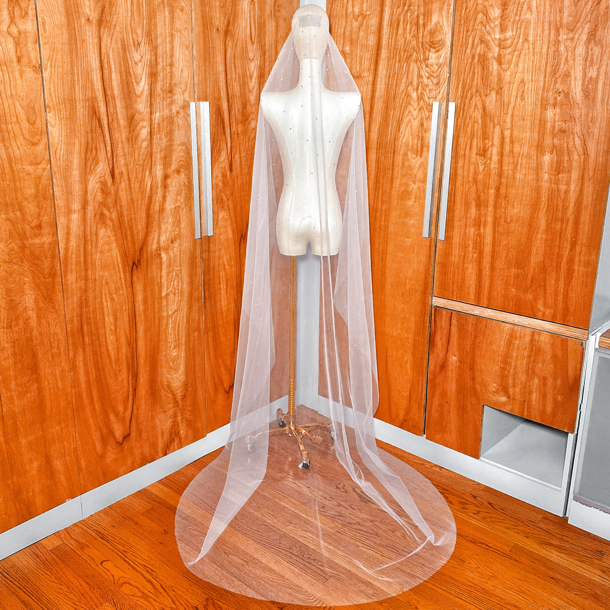 Luxury cathedral wedding veil showcasing a traditional scattered rhinestone mantilla design.