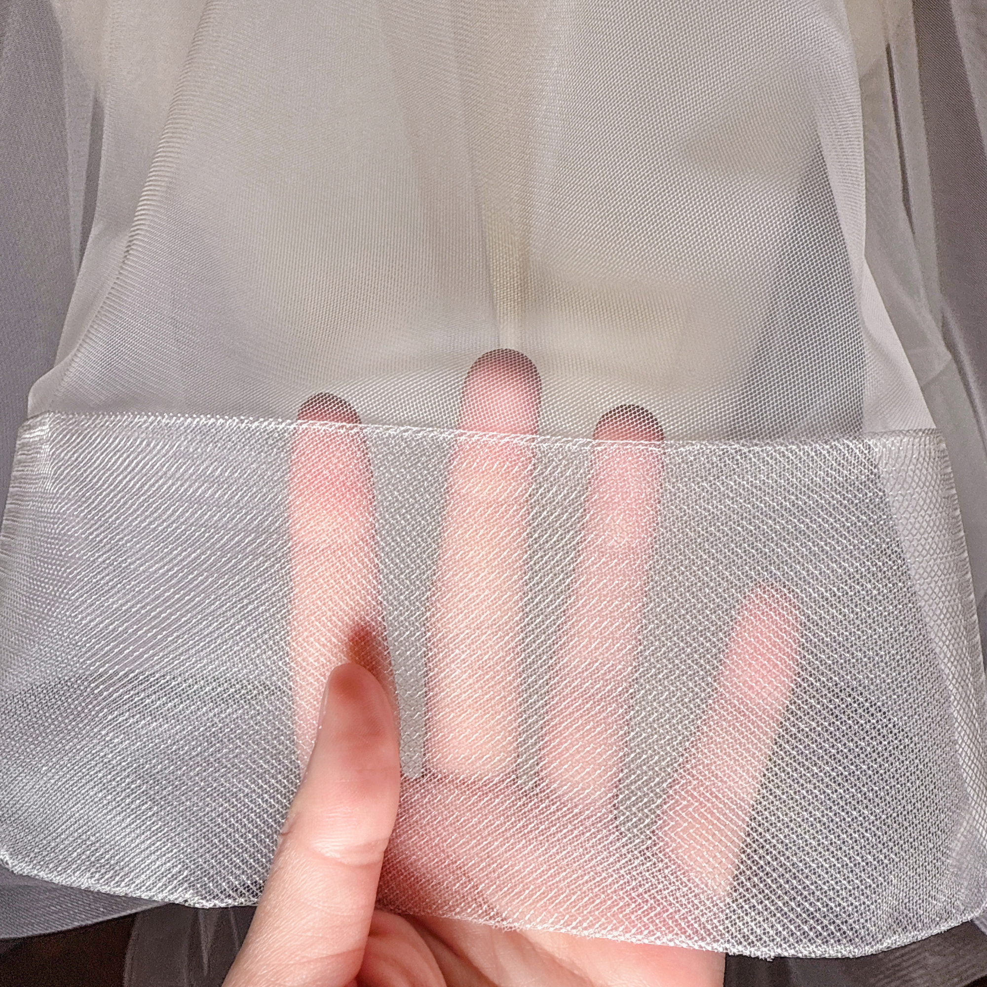 Close-up of the 3 inch horsehair trim on a two tier cathedral length wedding veil with blusher.