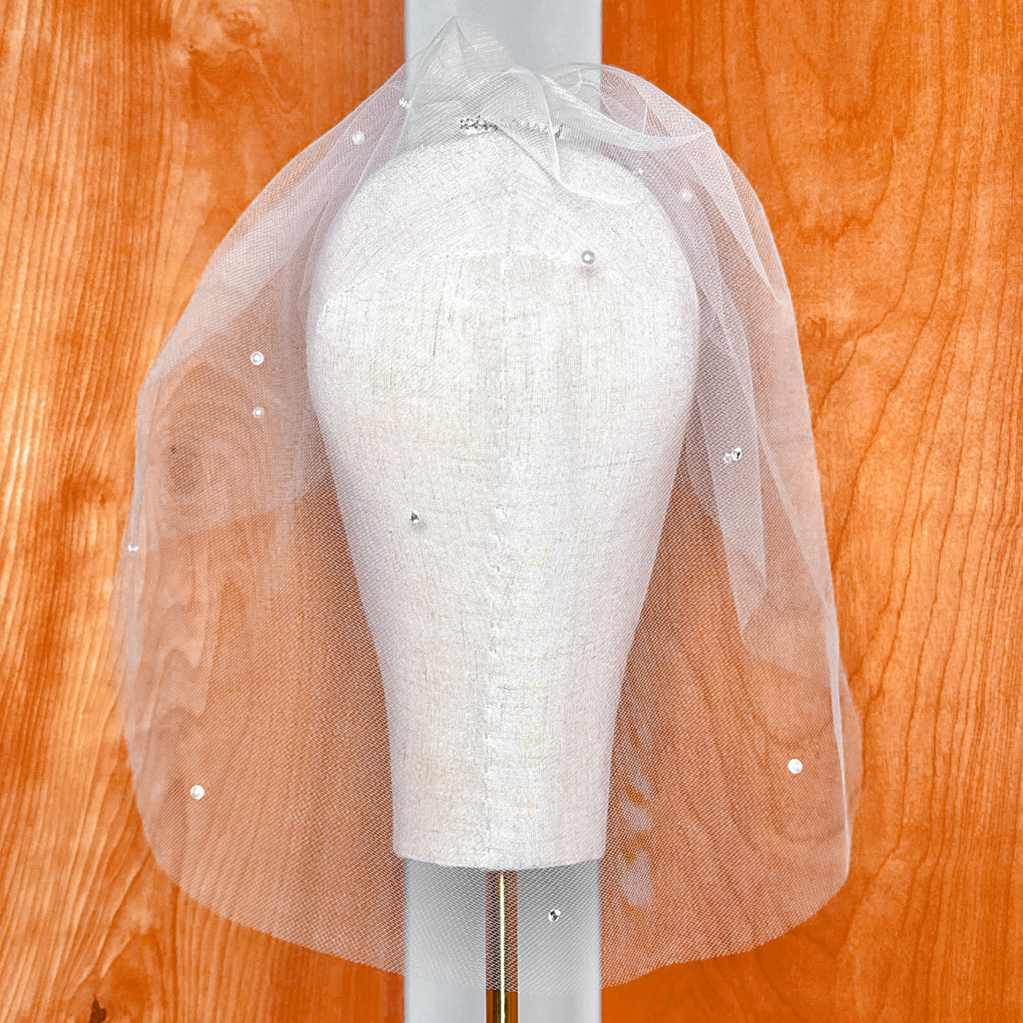 Luxury tulle birdcage wedding veil accented with sparkling rhinestones and elegant pearls.