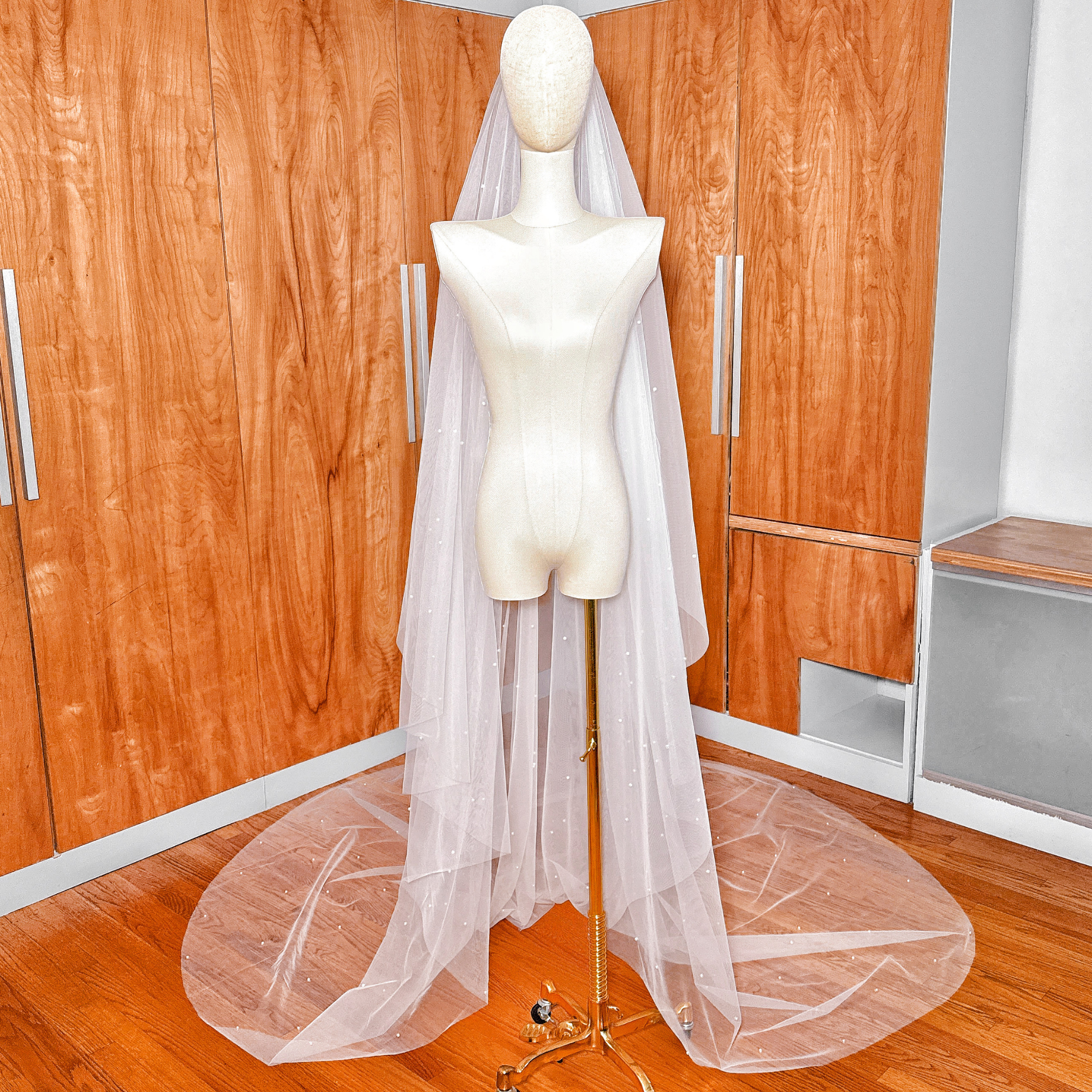Elegant cathedral length two tier scattered pearl wedding veil for a traditional bridal look.