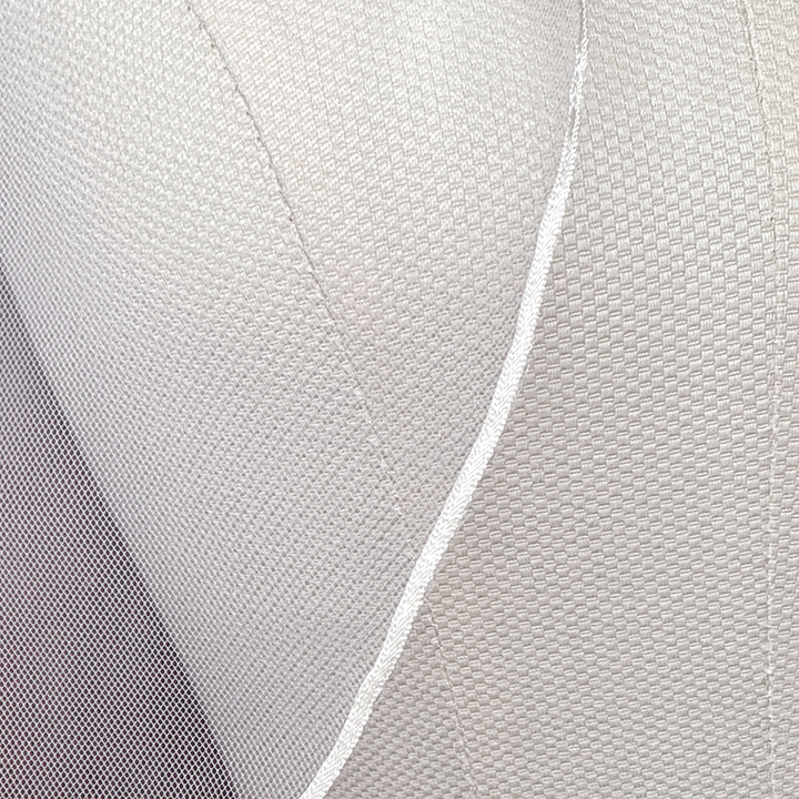 Close-up shot showing the delicate micro ribbon trim on a fingertip length wedding veil.