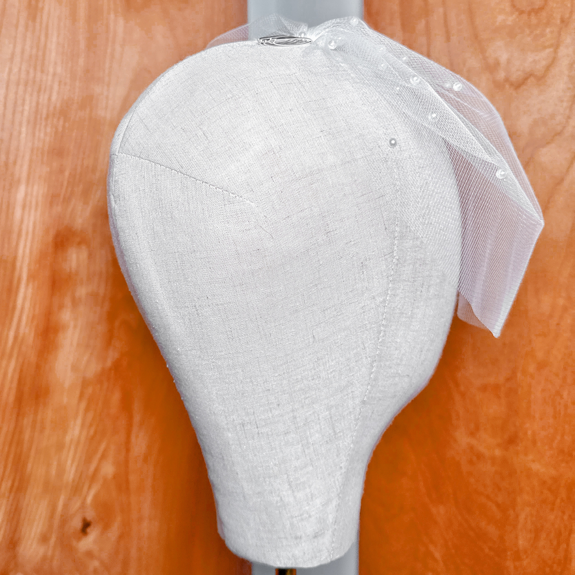 Three-quarter angle of the bridal mini birdcage wedding veil with pearls showcasing its volume.