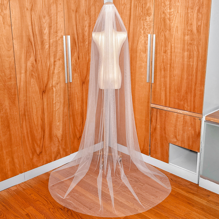 A minimalist simple chapel length raw edge veil styled for a modern bridal look.