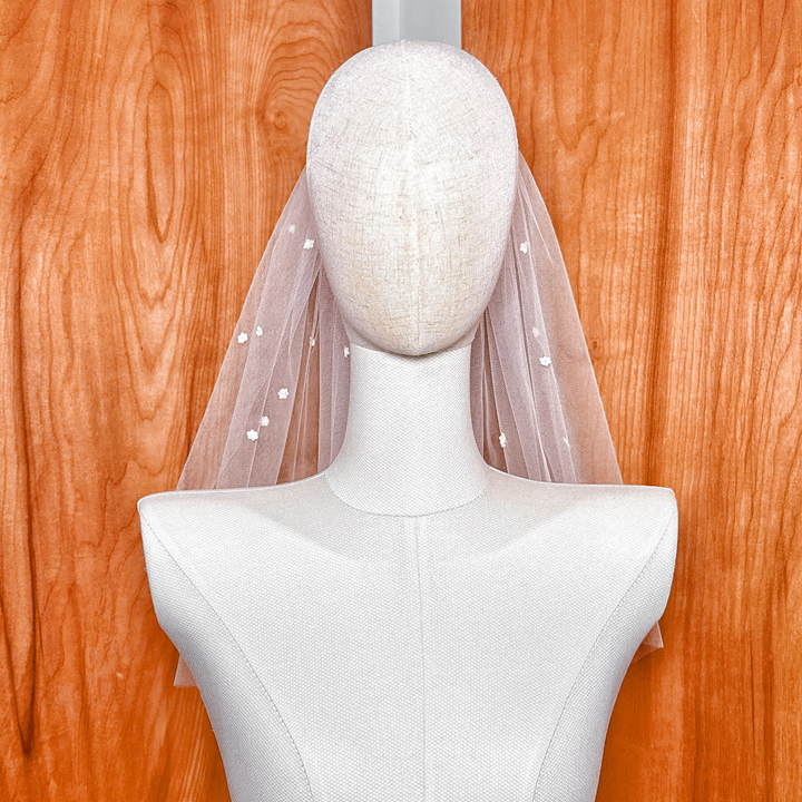 Studio display of the veil under bright lighting, emphasizing its transparency and weightless silhouette.