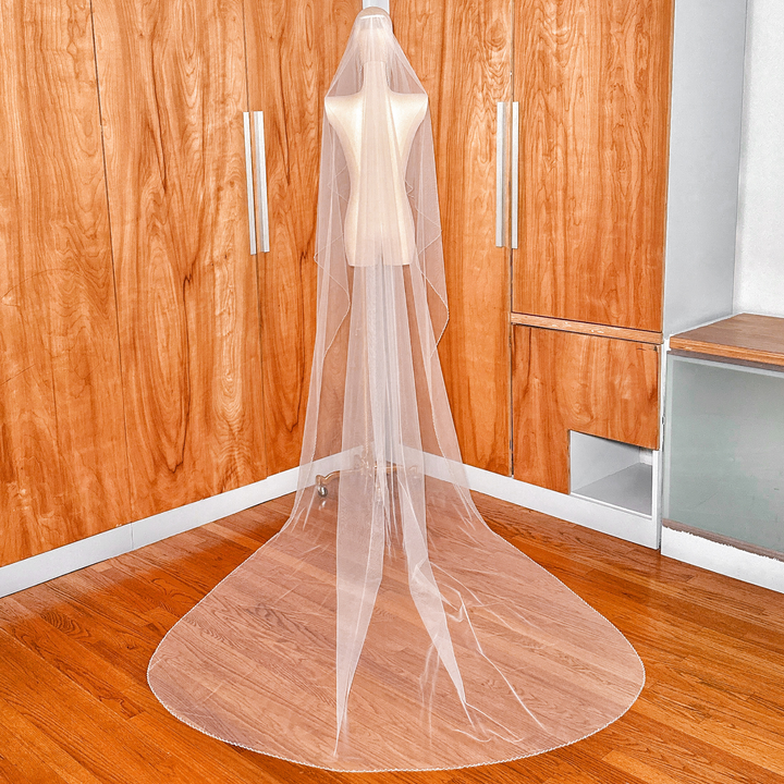 Rear view of a long angel cut pearl trim wedding veil showing the sweeping cathedral length.
