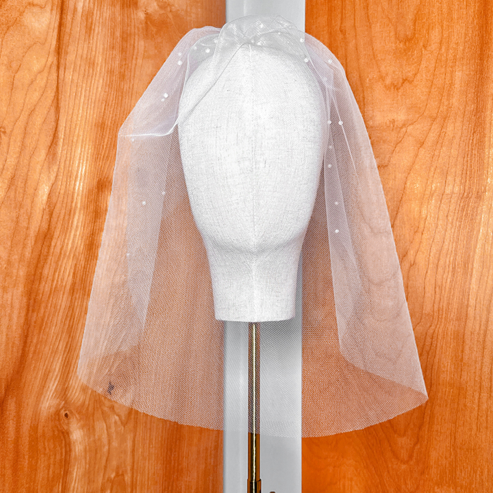 Front view of a white pearl birdcage wedding veil.