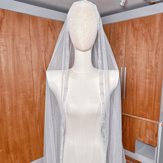 Intricately beaded cathedral veil with a scattering of pearls and crystals on sheer tulle.