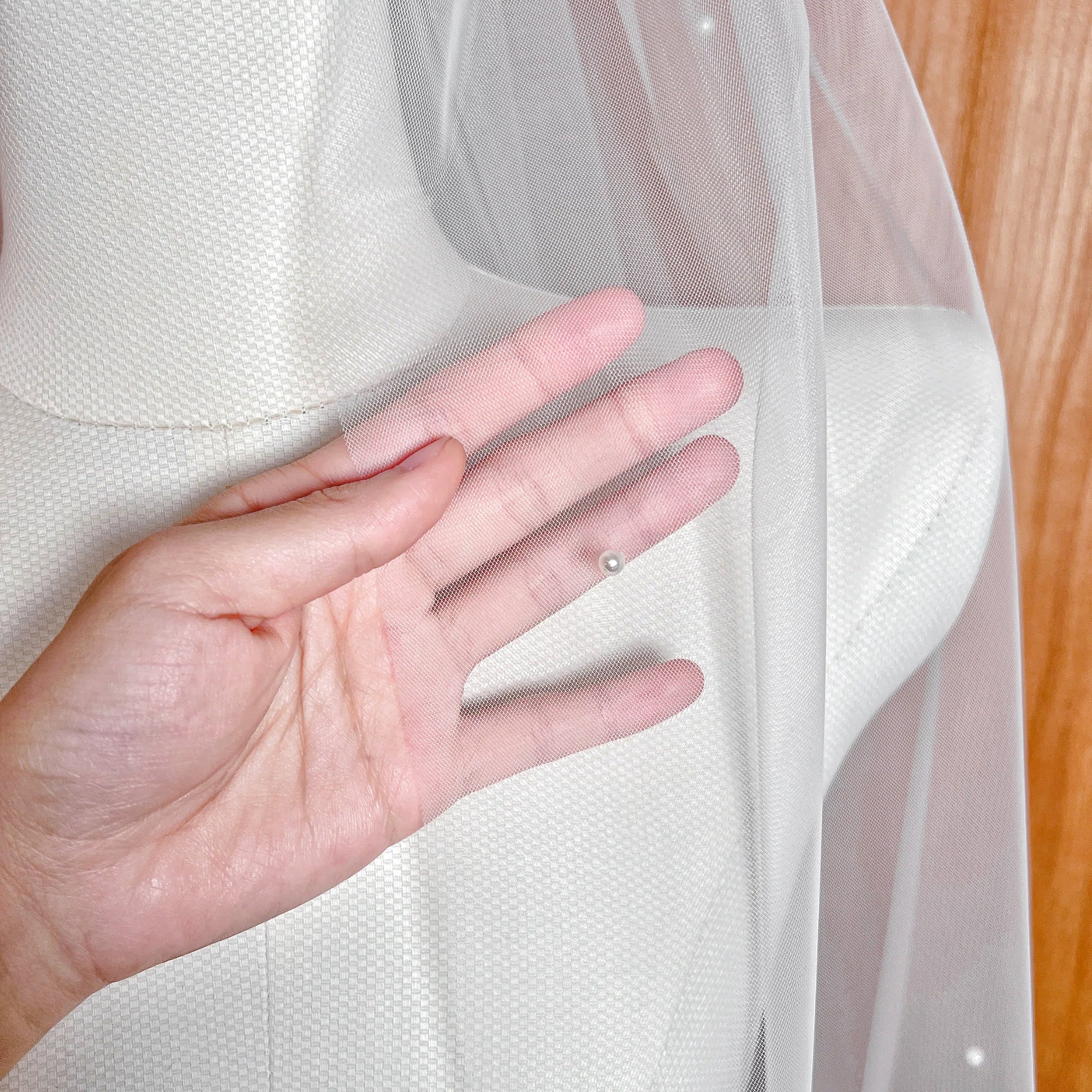 Close-up detail of the hand-placed pearls on the Lightly Scattered Pearl Wedding Veil.