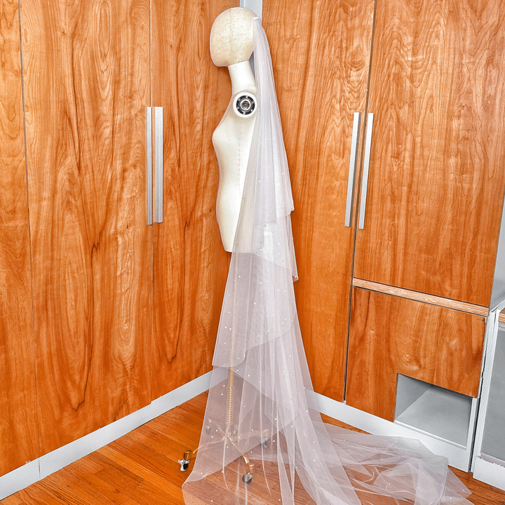 Scattered pearls detail on a two tier wedding veil with a blusher in cathedral length.