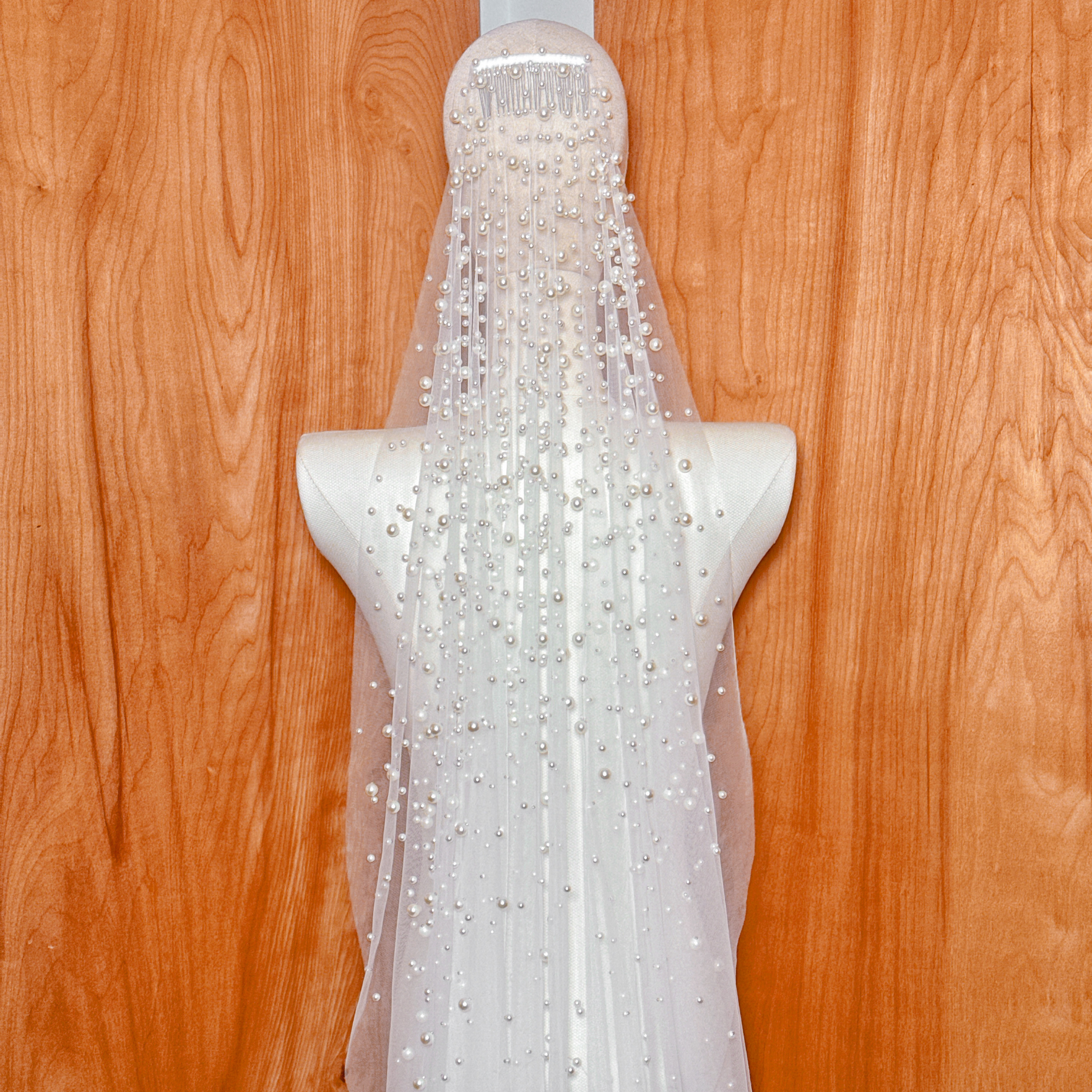 Close-up of the delicate pearl embellishments on a cathedral length mantilla bridal veil.