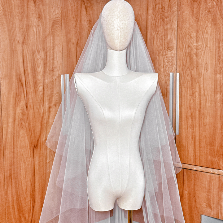 Detailed view of the raw edge finish on a two-tier cathedral tulle wedding veil.