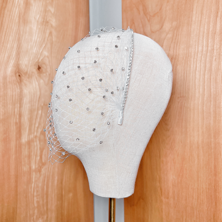 Side profile view of the rhinestone birdcage wedding veil showcasing its shape and drape.