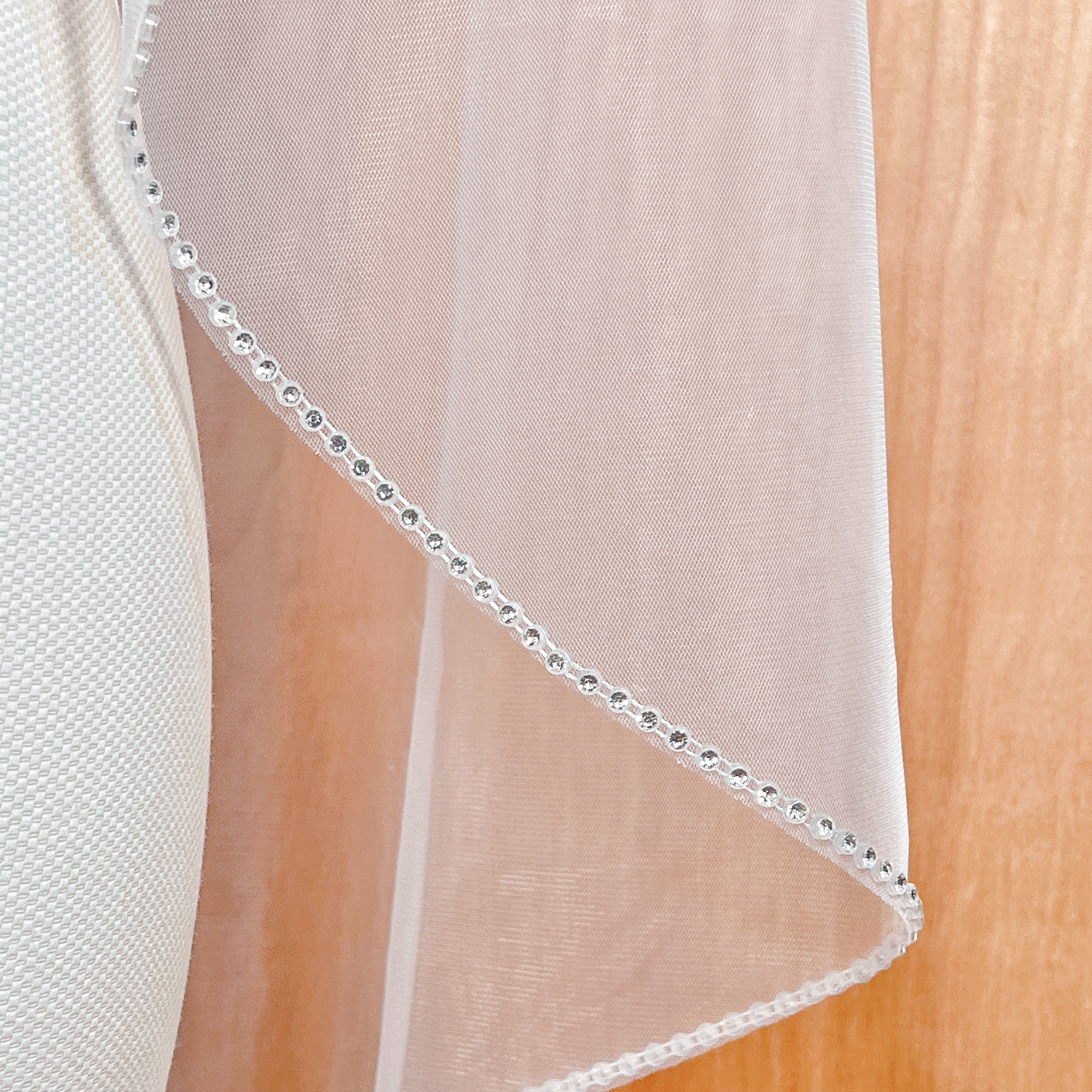 Close-up of the sparkling crystal borders on a rhinestone edge wedding veil.
