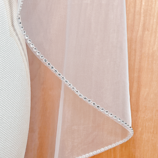 Close-up of the sparkling crystal borders on a rhinestone edge wedding veil.