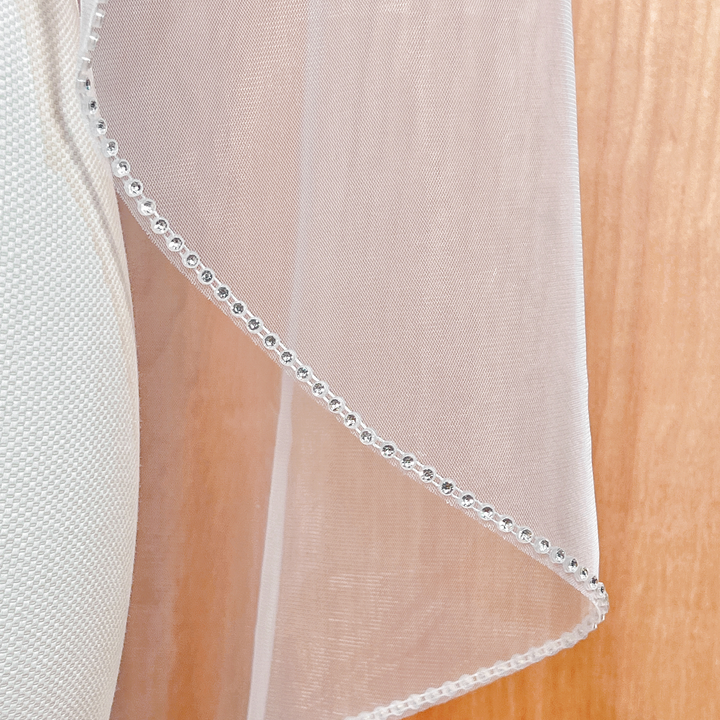 Close-up of the sparkling crystal borders on a rhinestone edge wedding veil.