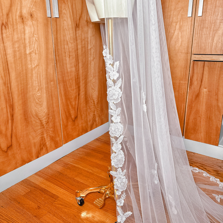 Detailed view of the intricate trim on a Scalloped Lace Edge Royal Cathedral Veil.