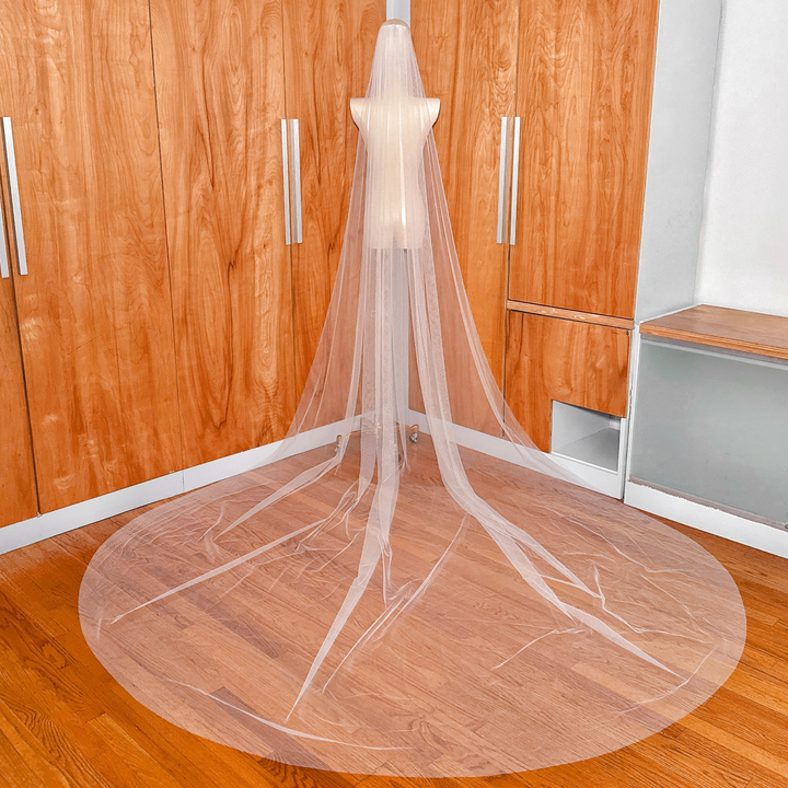 Back view of a long Royal Cathedral Tulle Wedding Veil showing the elegant drape and sheer tulle texture.