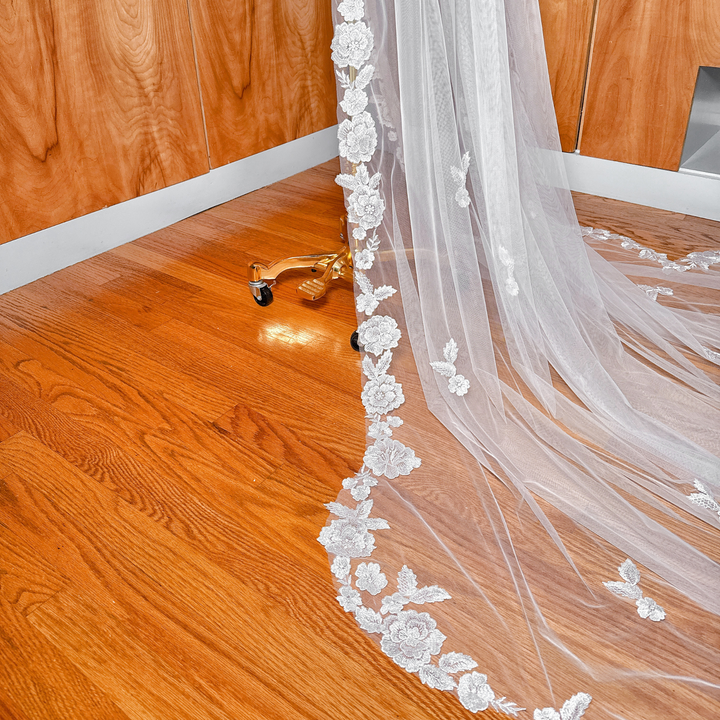 Scalloped Lace Edge Royal Cathedral Veil draped elegantly over a bridal mannequin.