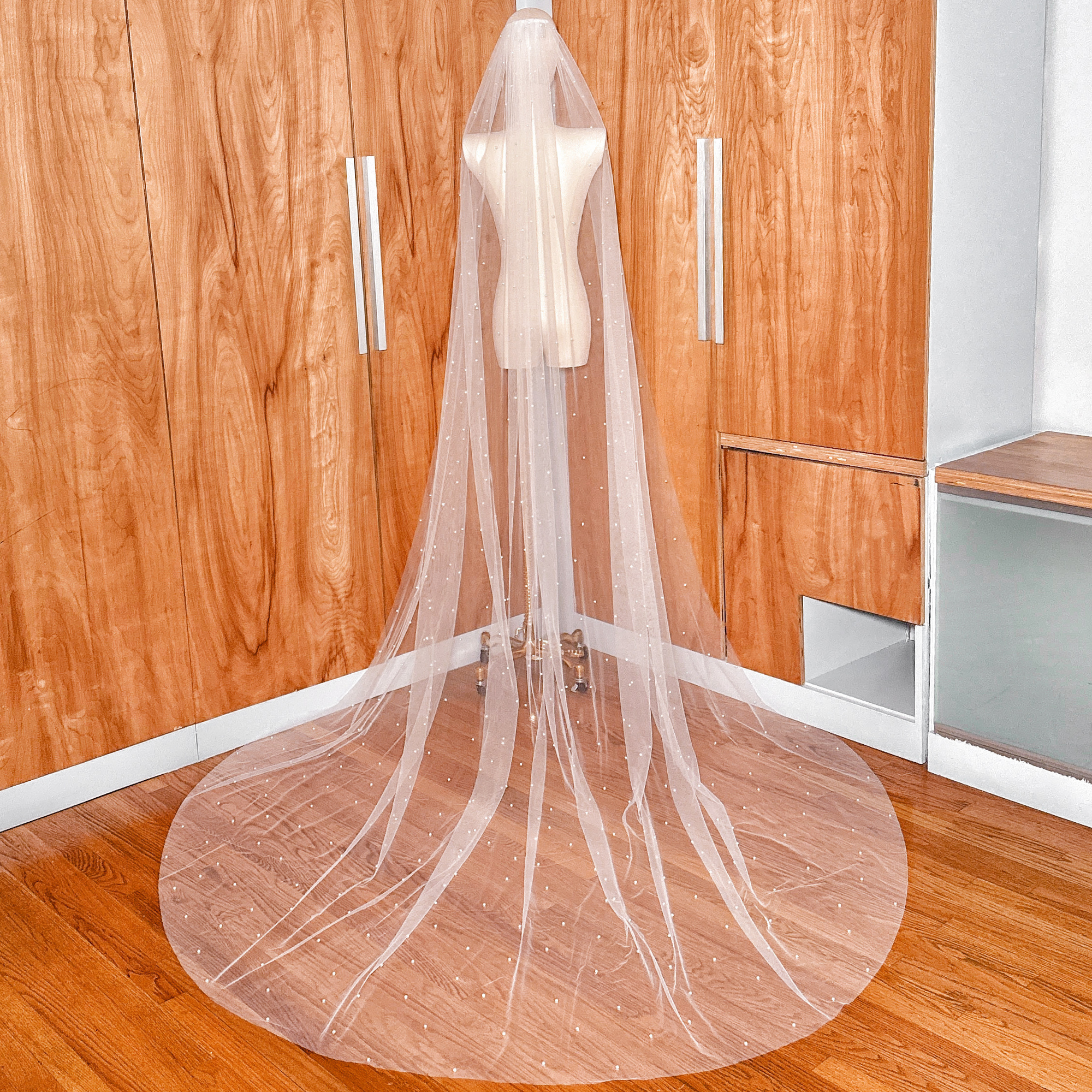 Back view of a 108-inch cathedral length wedding veil featuring a delicate scatter of shimmering pearls.