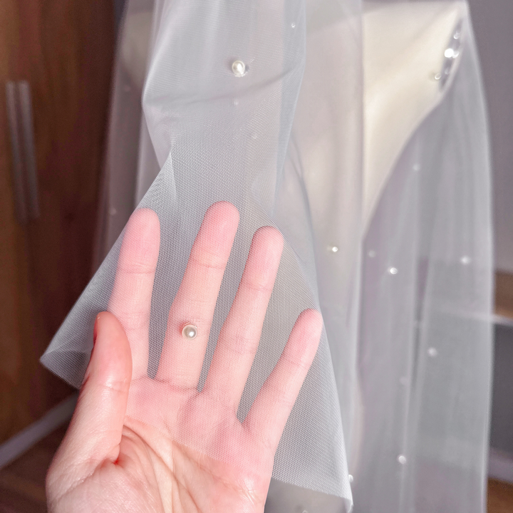 Close-up of a two tier scattered pearl wedding veil showing the delicate drop veil style.