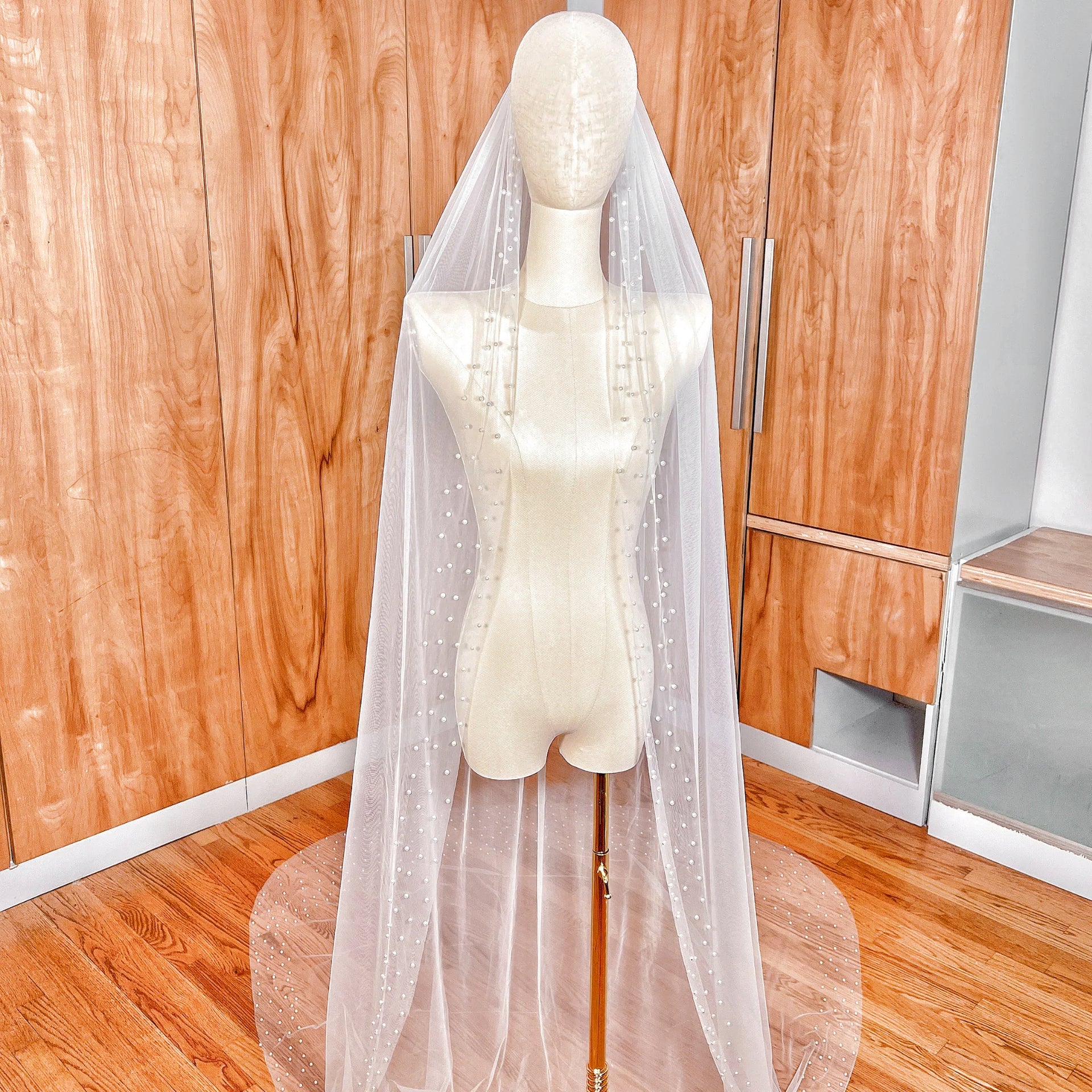 Front view of the Scattered Pearl Edge Wedding Veil in a dramatic cathedral length with pearls concentrated along the bottom edge.