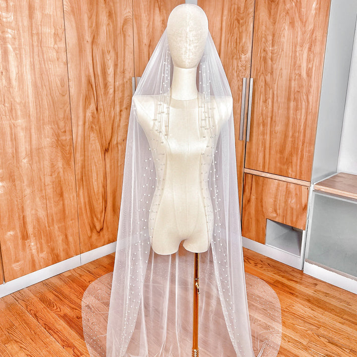 Front view of the Scattered Pearl Edge Wedding Veil in a dramatic cathedral length with pearls concentrated along the bottom edge.
